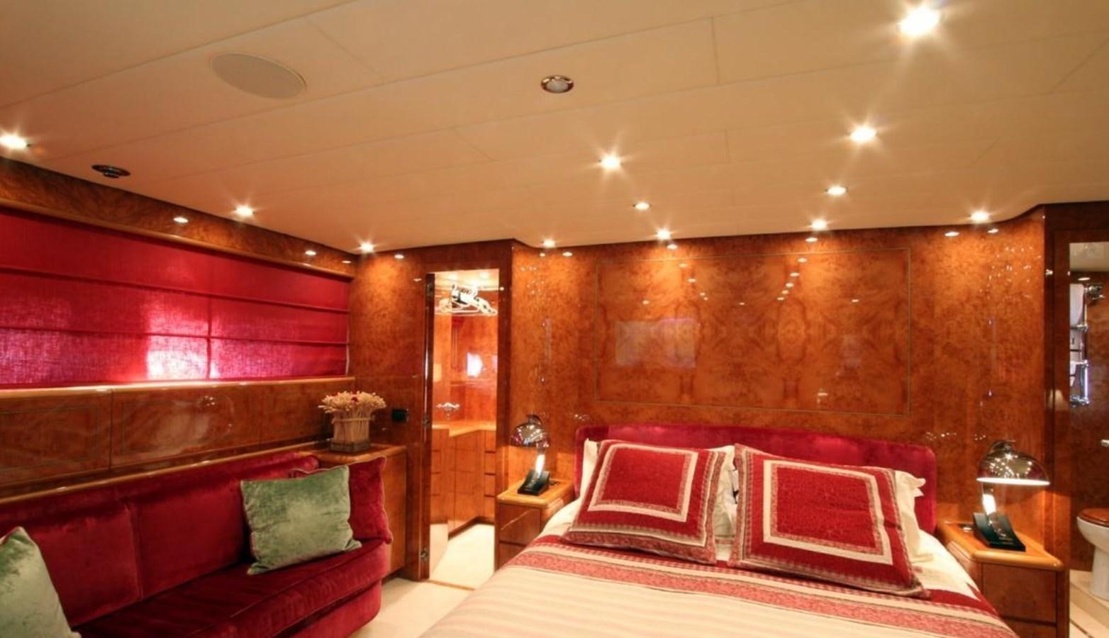 a bedroom with a bed and a wood wall aboard MAGENTA I Yacht for Sale