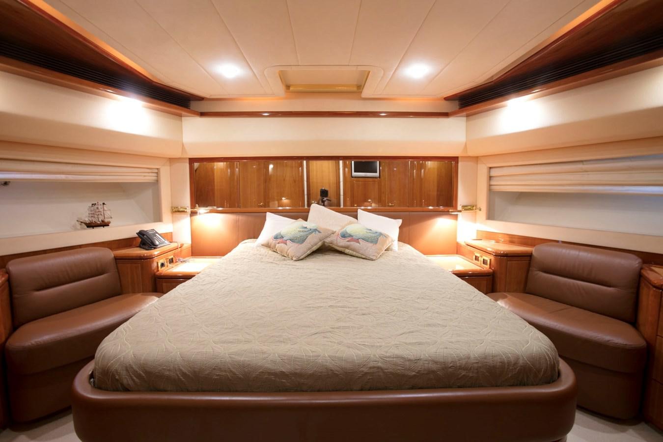 a hotel room with a bed and couches aboard LADY VICTORIA Yacht for Sale