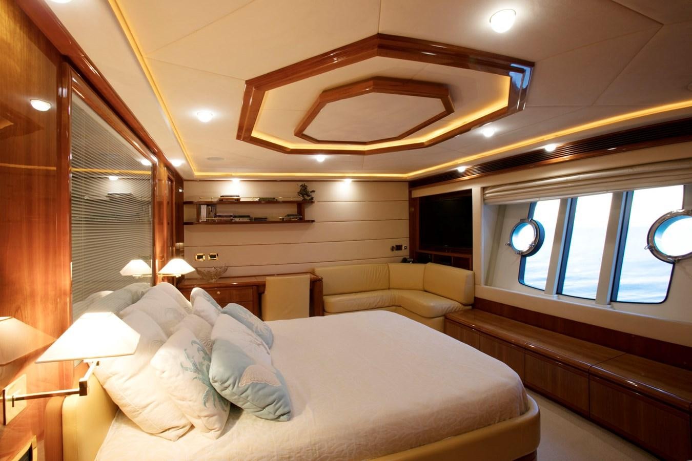 a room with a bed and a window aboard LADY VICTORIA Yacht for Sale