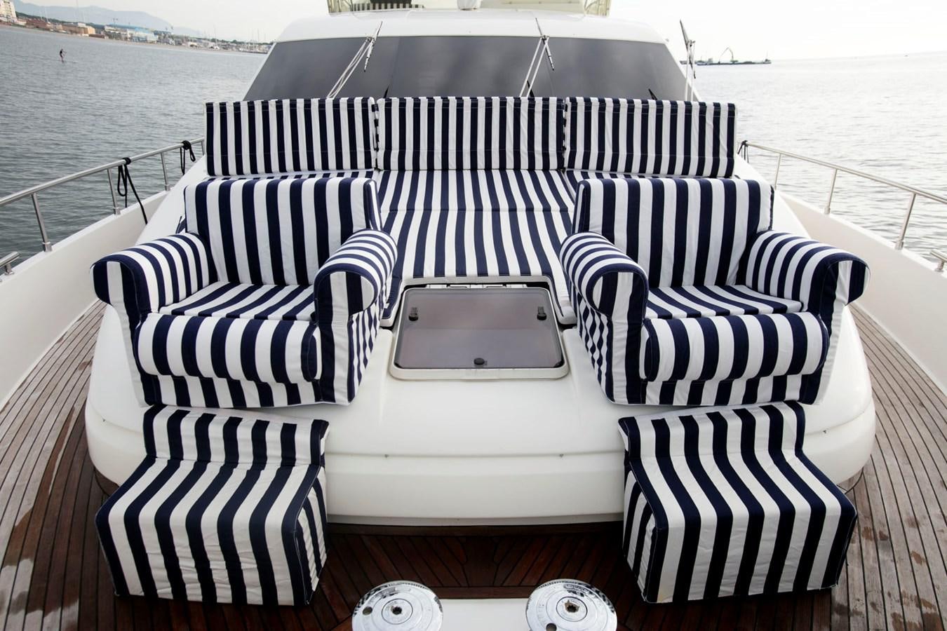 a white and black striped chair on a boat aboard LADY VICTORIA Yacht for Sale