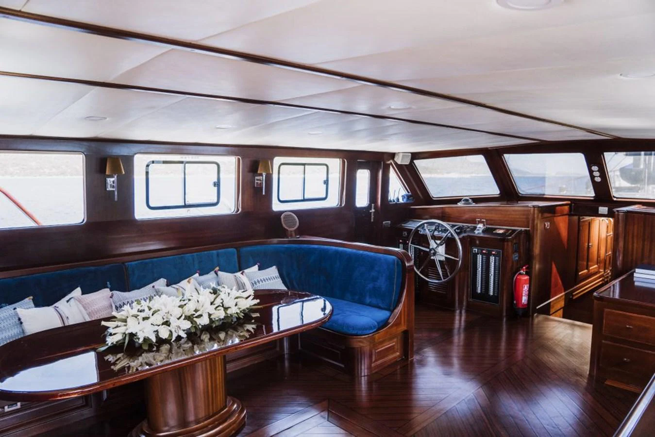 a room with a table and chairs aboard CAPRICORN 1 Yacht for Sale