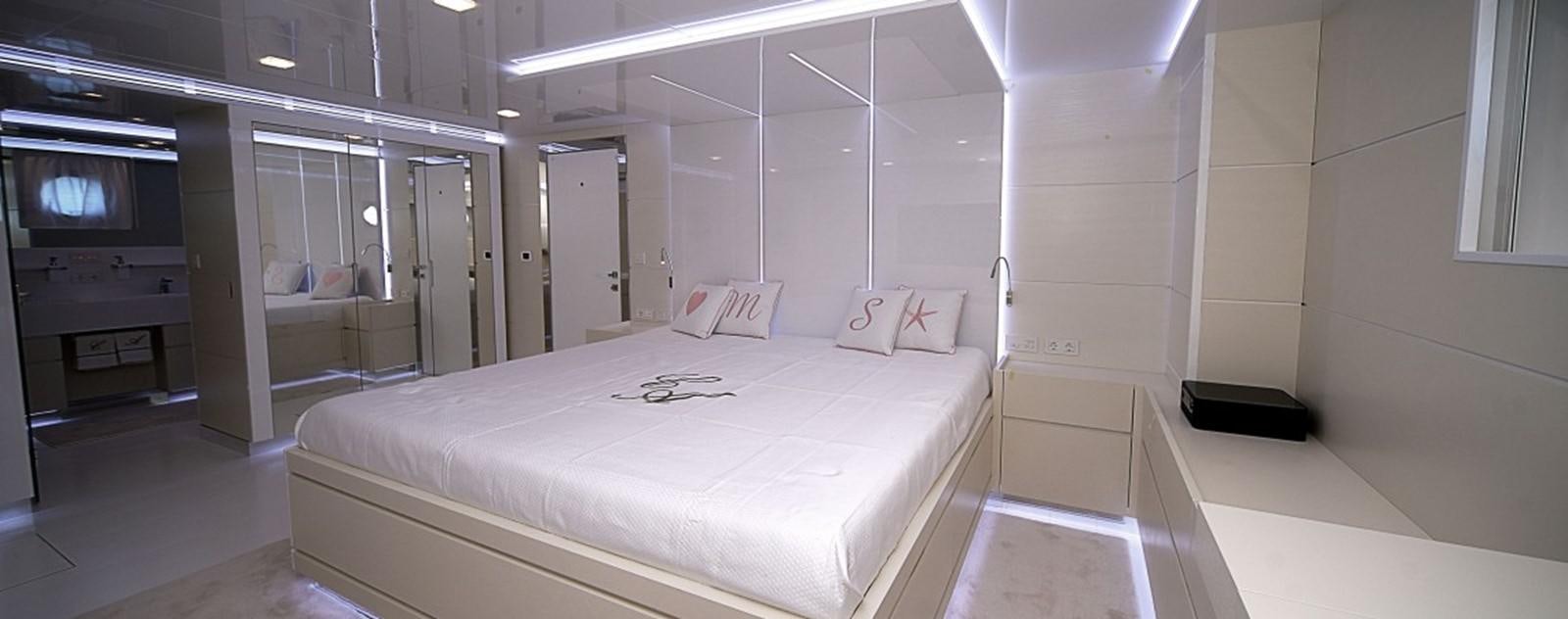 a room with a bed and a television aboard OCEAN KING 88 Yacht for Sale