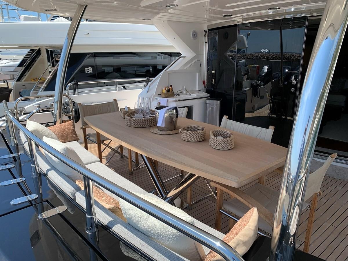 a room with a table and chairs aboard KAPUSHA Yacht for Sale