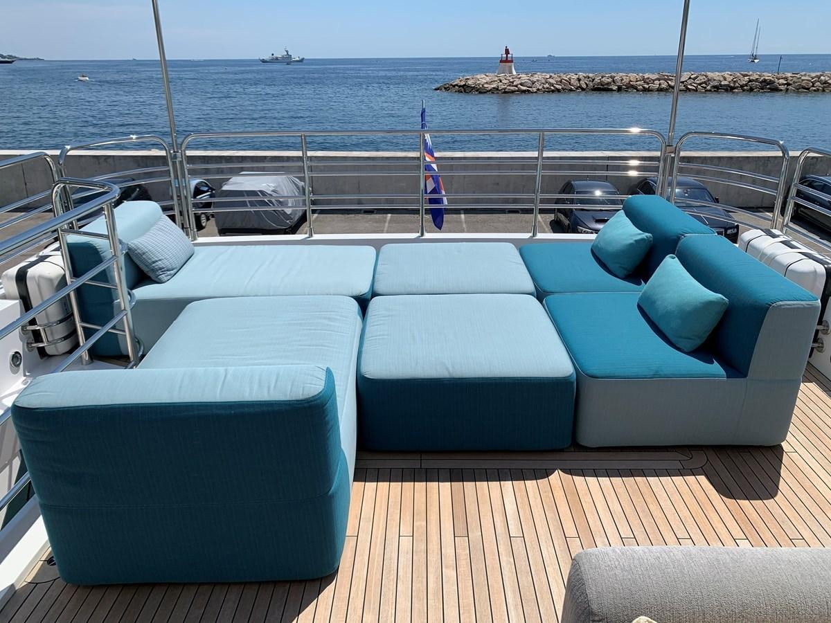 a deck with chairs and a body of water in the background aboard KAPUSHA Yacht for Sale