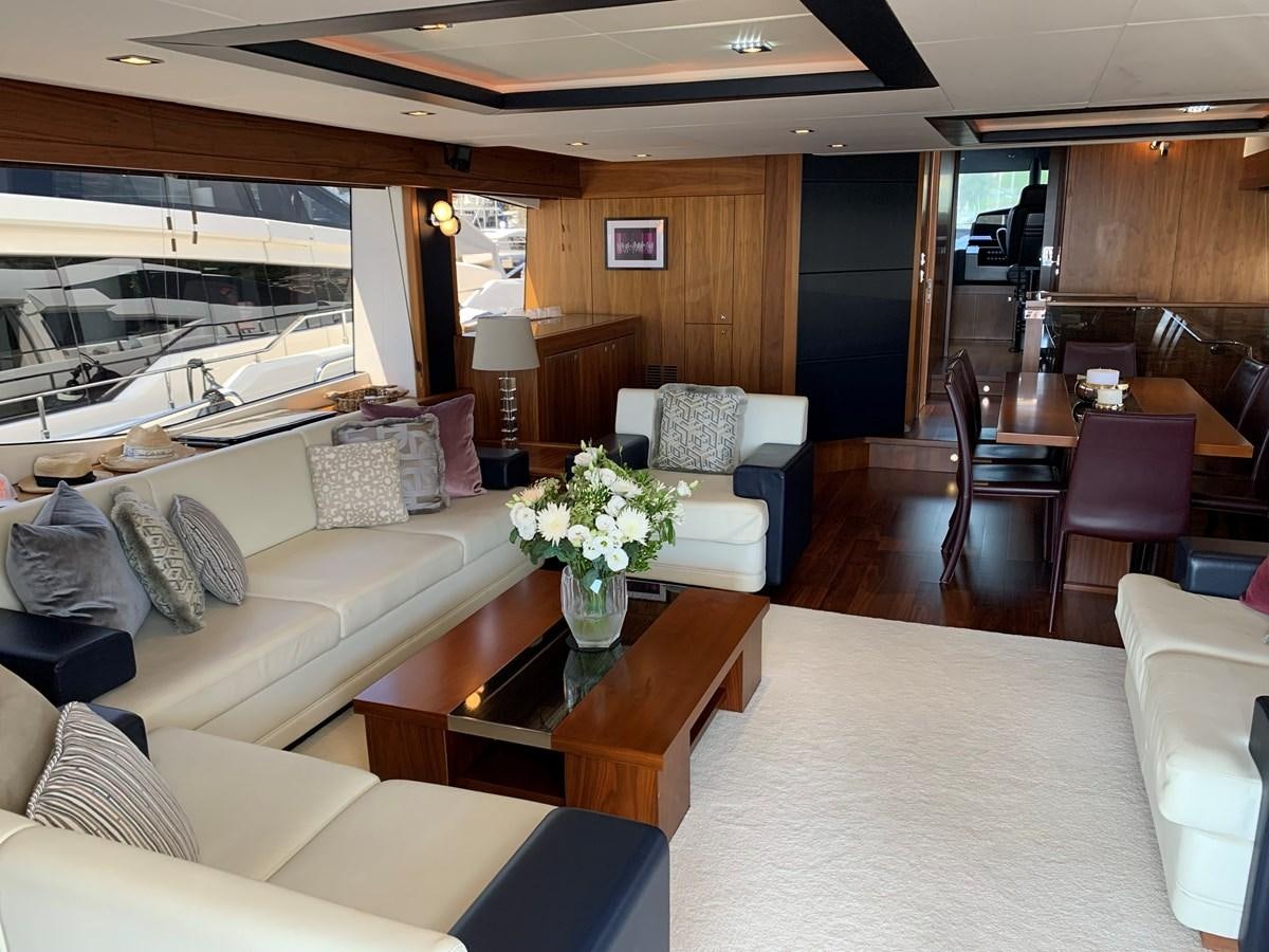 a living room with a couch and a table aboard KAPUSHA Yacht for Sale