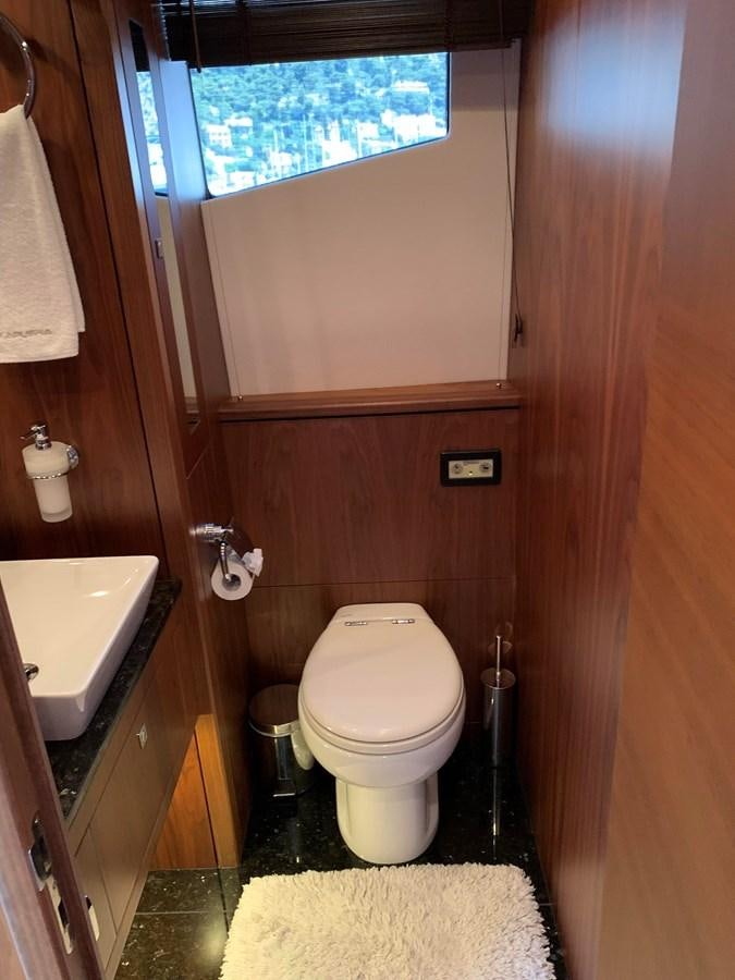 a bathroom with a toilet and a sink aboard KAPUSHA Yacht for Sale