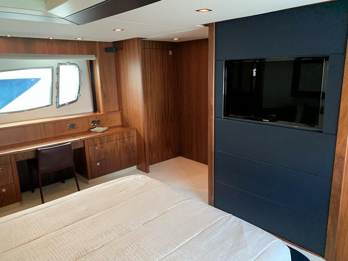 a room with a tv and a table aboard KAPUSHA Yacht for Sale
