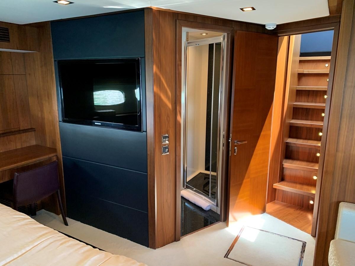 a room with a closet and a tv aboard KAPUSHA Yacht for Sale