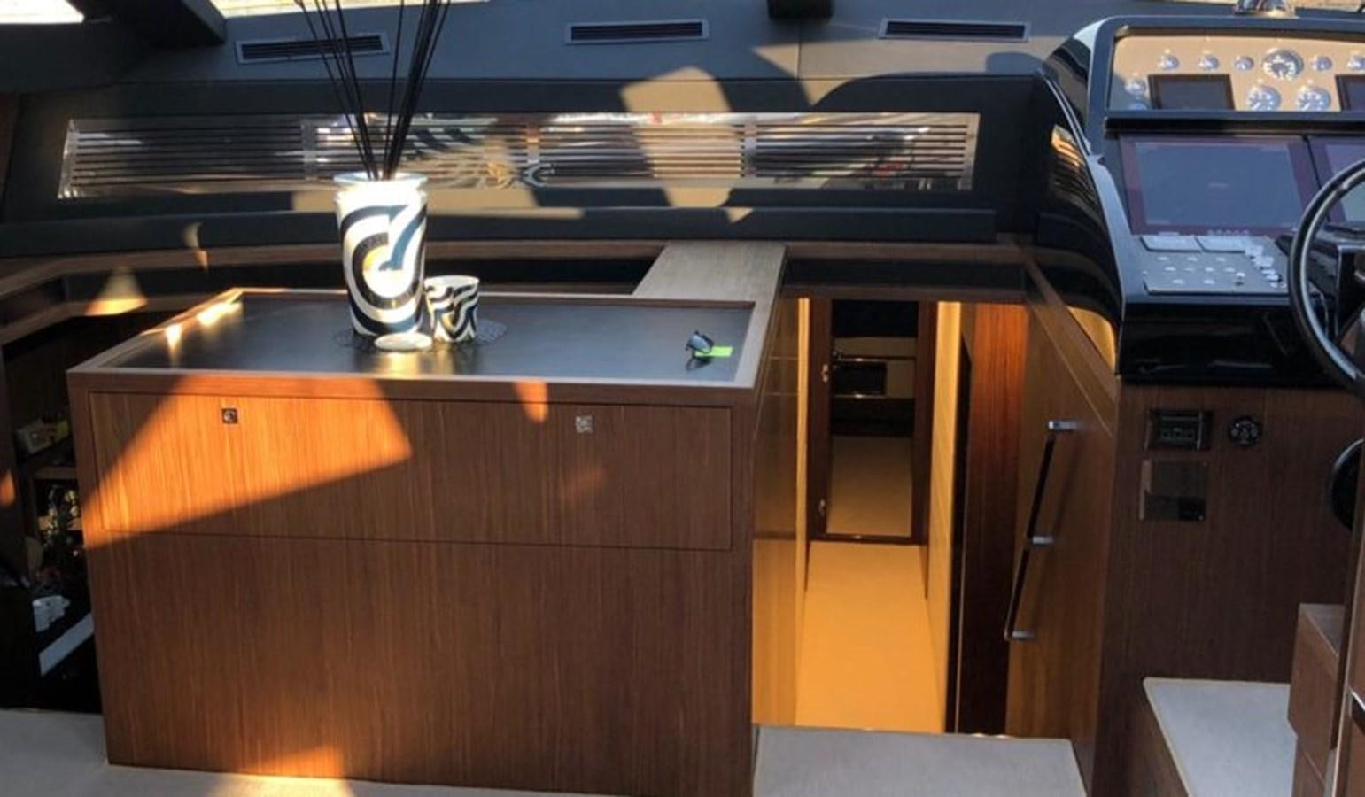 a coffee machine with a coffee cup on the counter aboard DOMINO Yacht for Sale