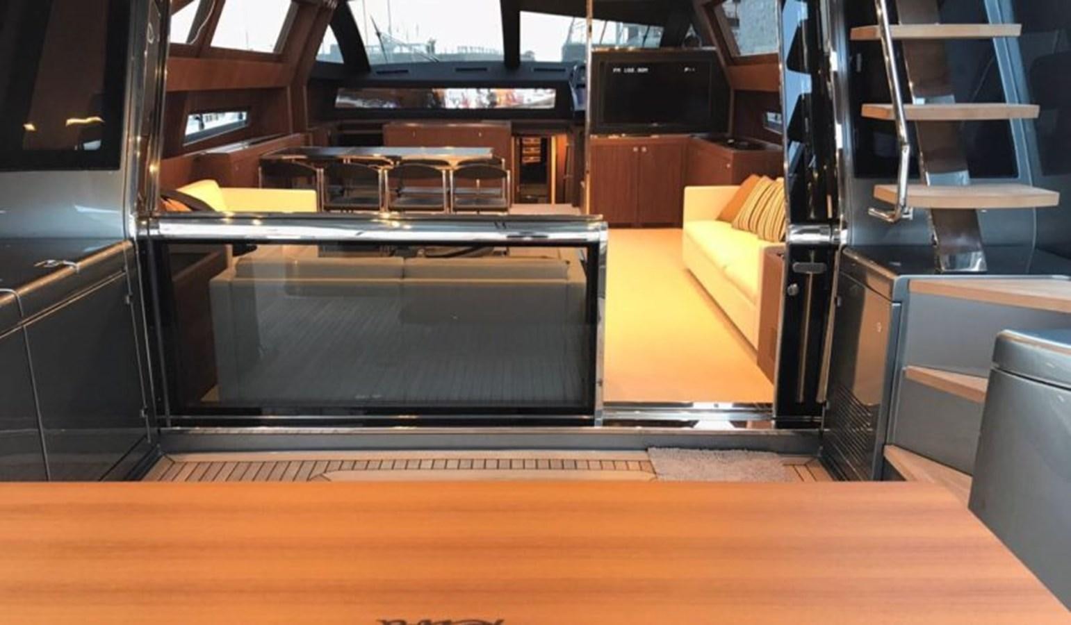 a large black rectangular object on a wooden surface aboard DOMINO Yacht for Sale