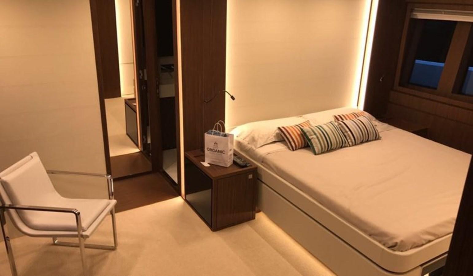 a bed and a chair in a room aboard DOMINO Yacht for Sale