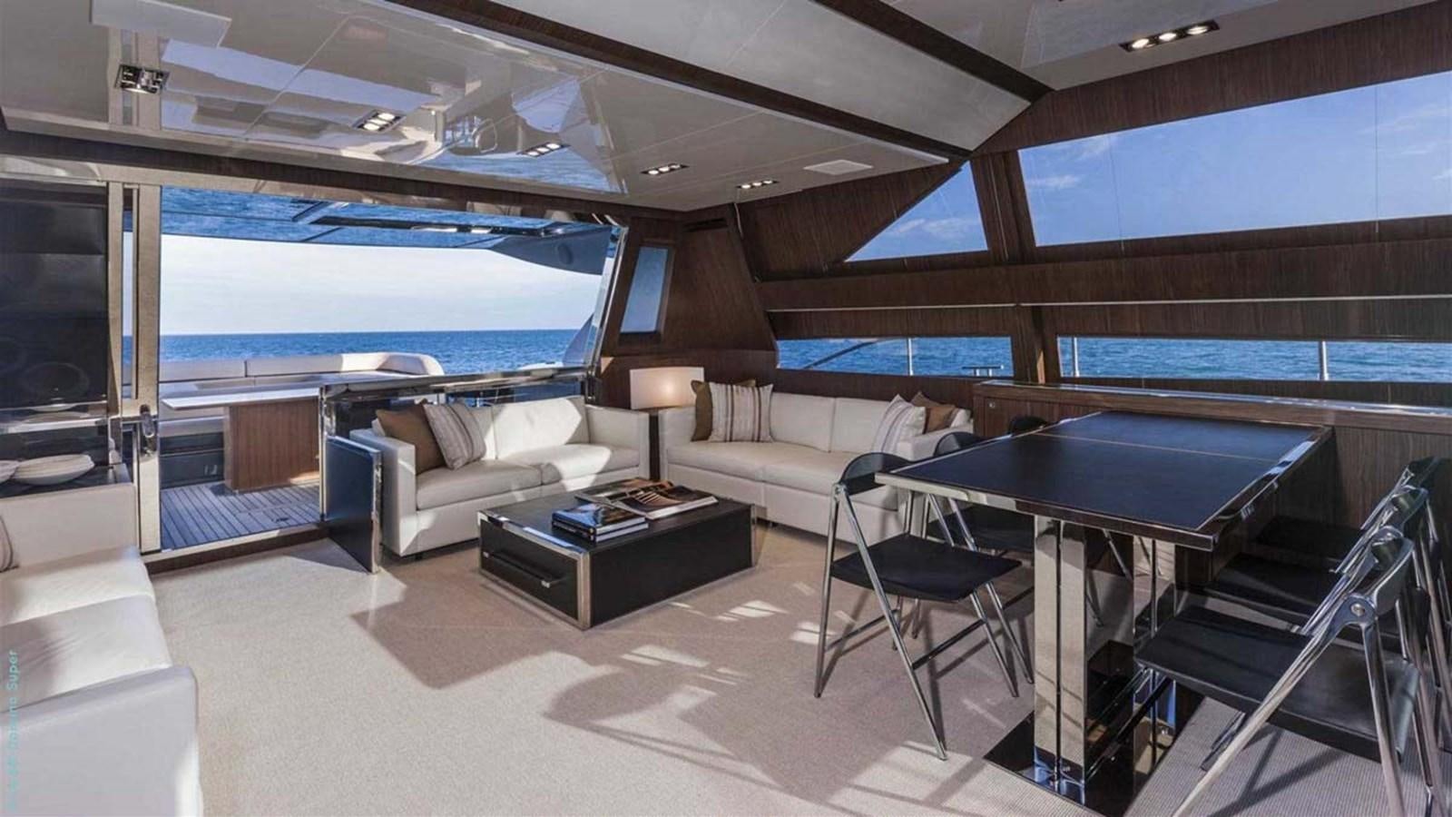 a room with a pool table and couches aboard FIRST SIGNS Yacht for Sale