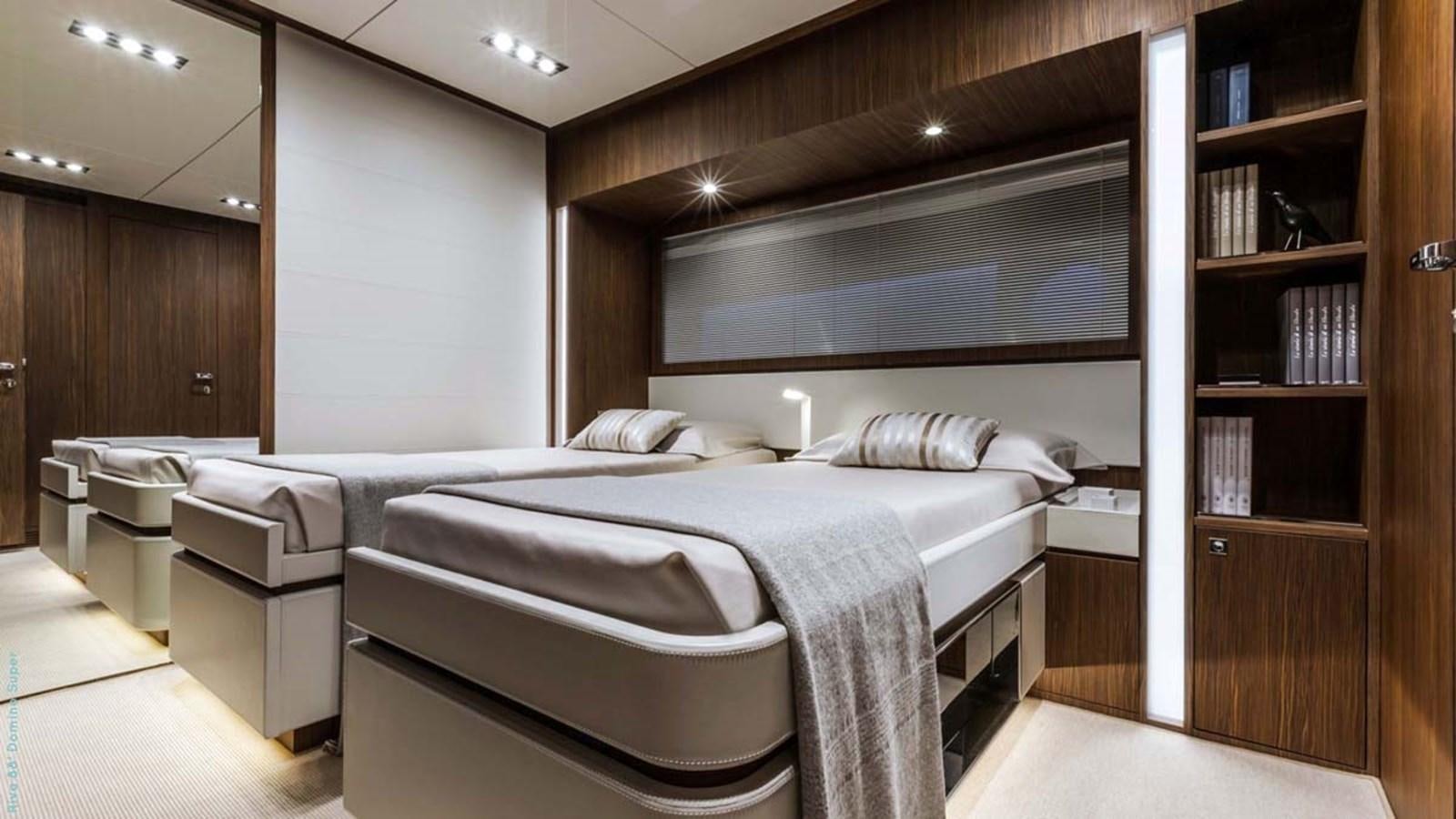 a room with a bed and a bookcase aboard FIRST SIGNS Yacht for Sale