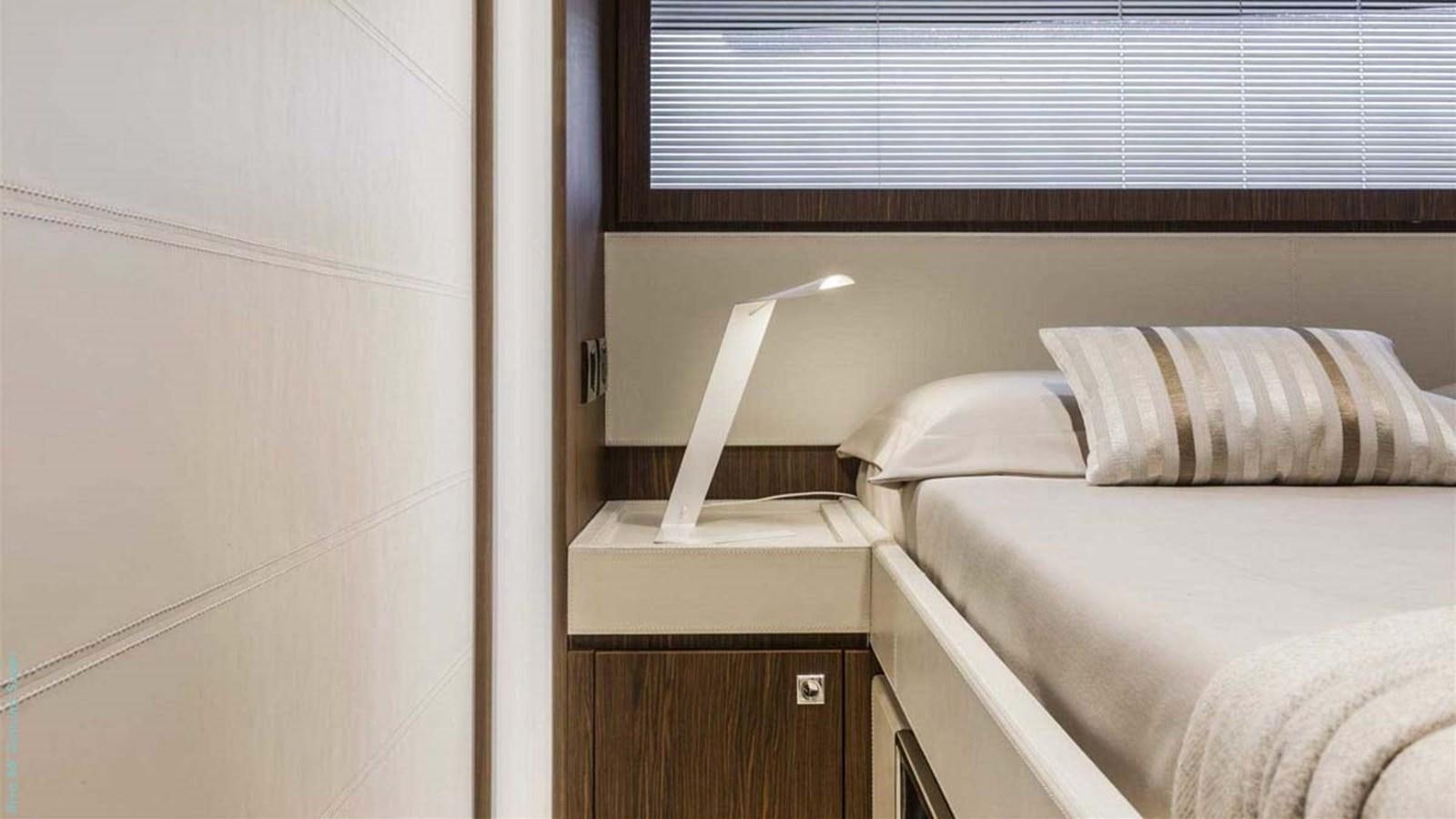 a bed with a lamp on it aboard FIRST SIGNS Yacht for Sale