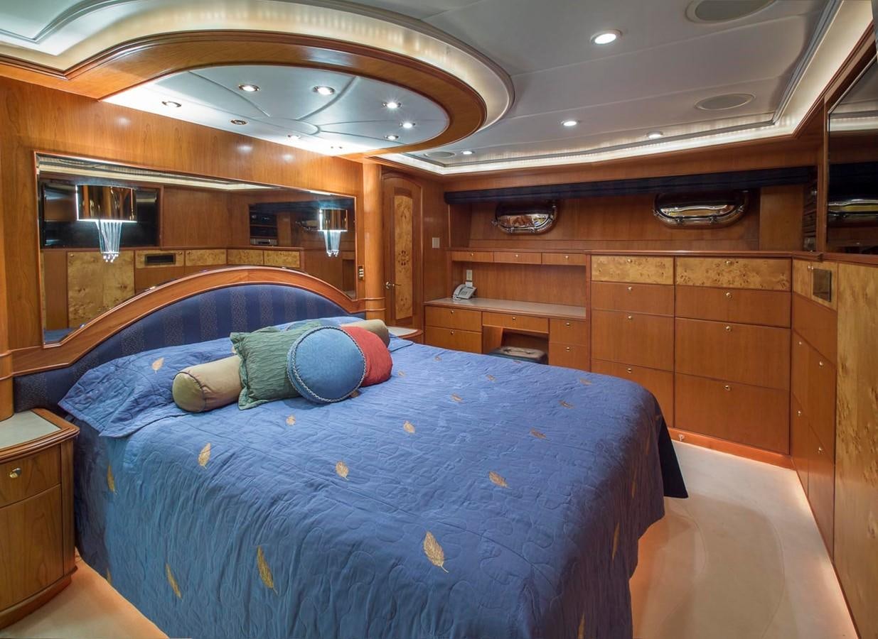 a bedroom with a bed and a wood wall aboard SILVER WINGS Yacht for Sale