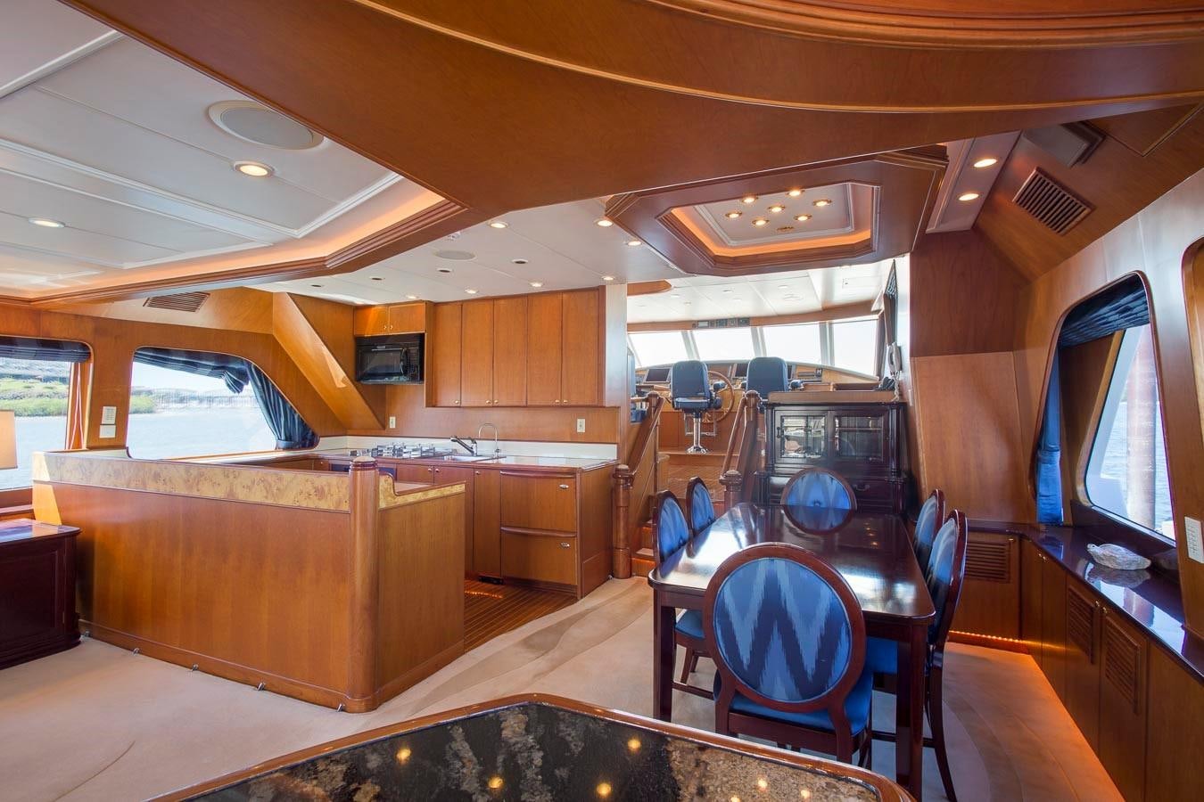 a kitchen with a bar and a table aboard SILVER WINGS Yacht for Sale