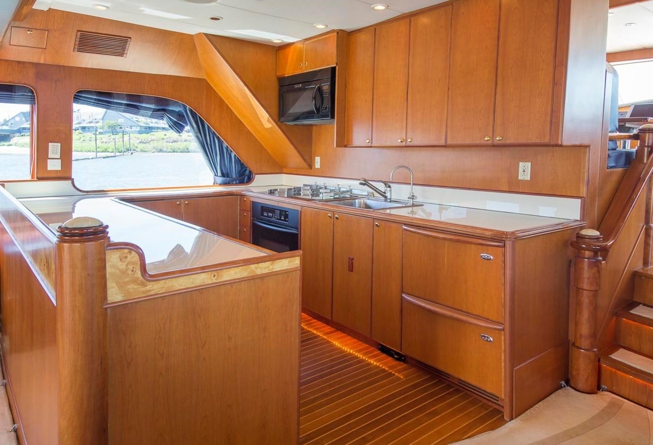 a kitchen with wooden cabinets aboard SILVER WINGS Yacht for Sale