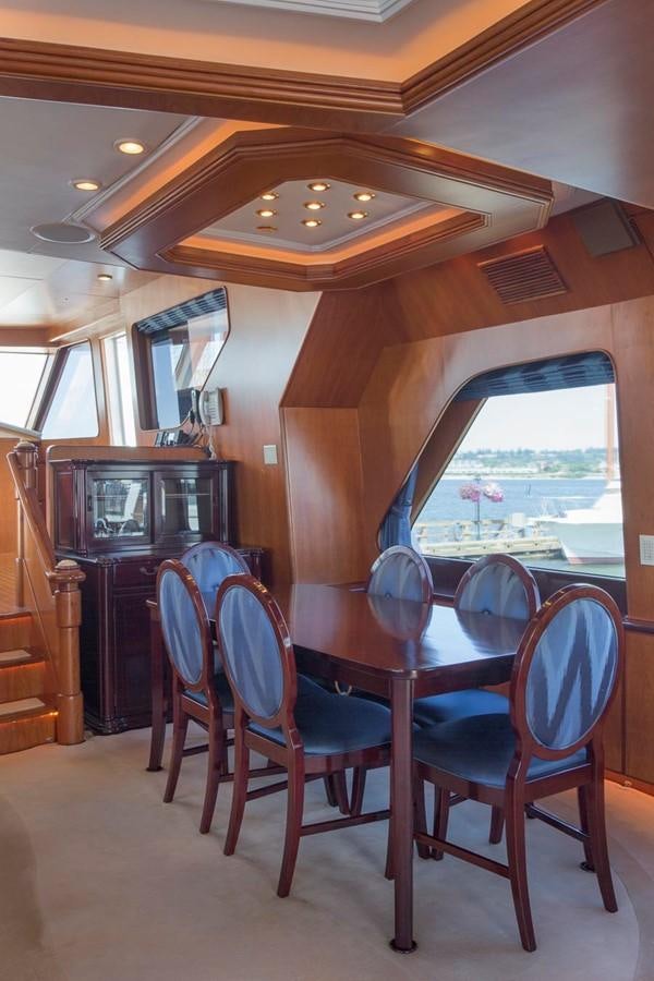 a dining table and chairs in a house aboard SILVER WINGS Yacht for Sale