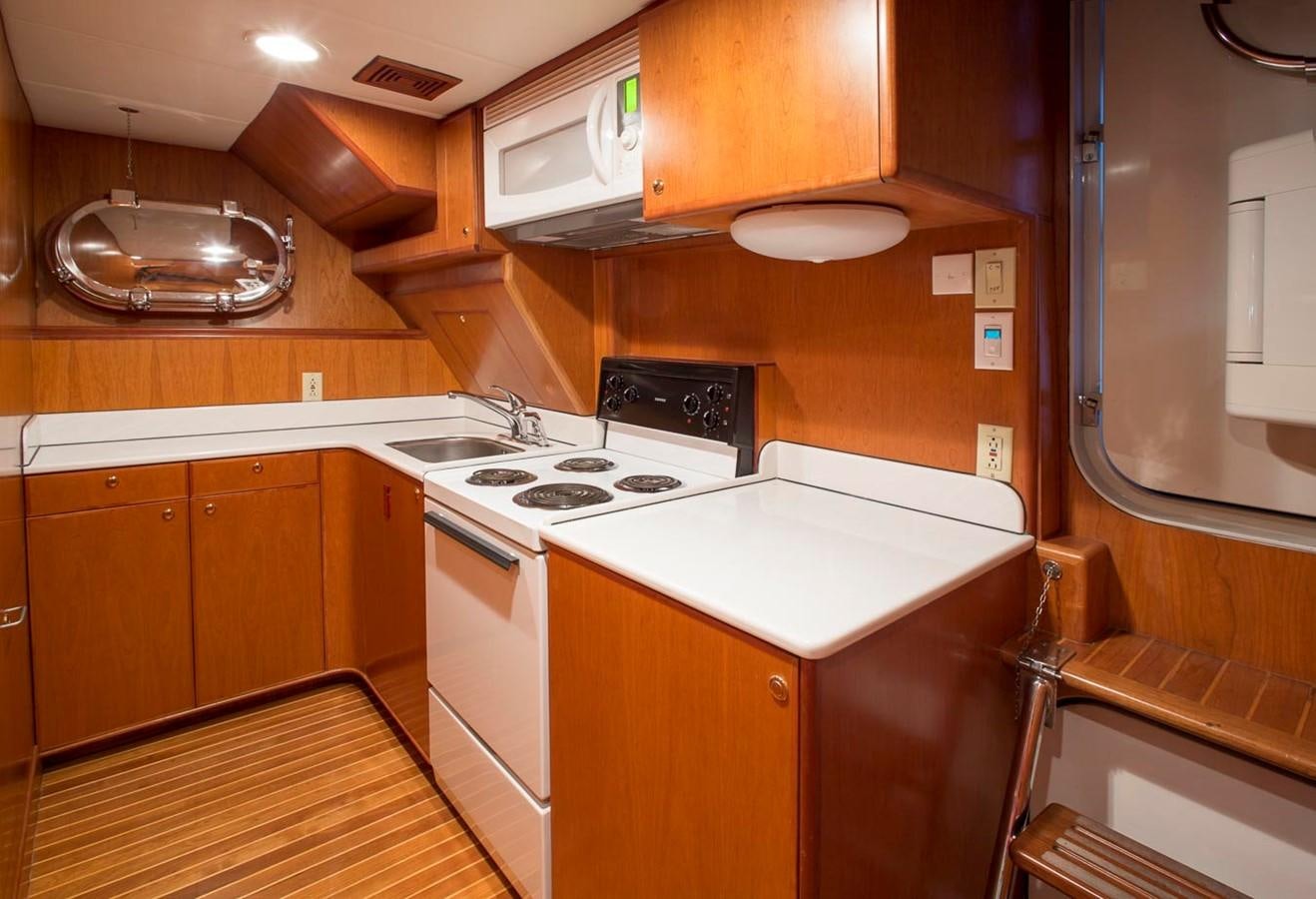 a kitchen with wooden cabinets aboard SILVER WINGS Yacht for Sale