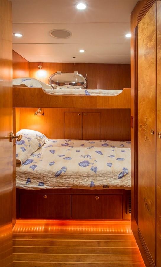 a bed with a blue and white bed spread aboard SILVER WINGS Yacht for Sale