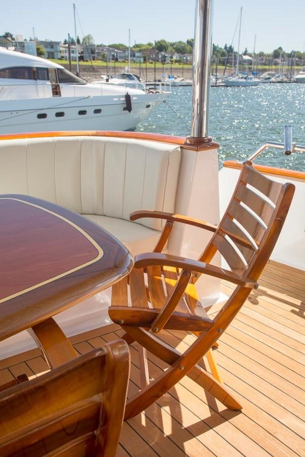 a wooden chair on a boat aboard SILVER WINGS Yacht for Sale