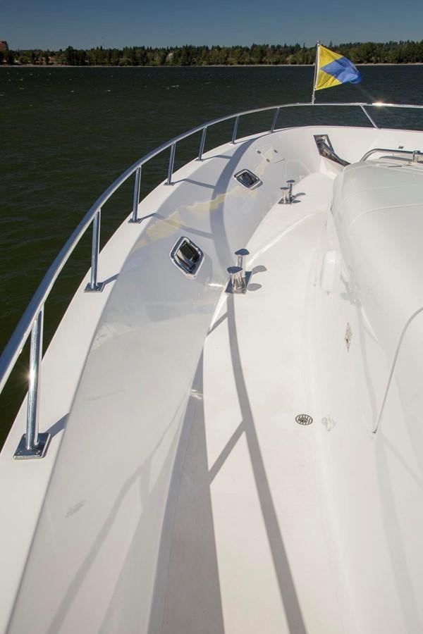 a boat with a flag on the front aboard SILVER WINGS Yacht for Sale