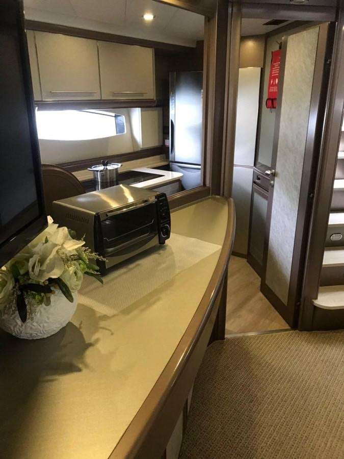 a kitchen with a microwave oven aboard PERSHING 90/12 Yacht for Sale