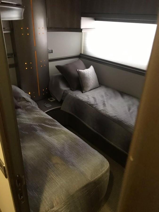 a bed with a white pillow aboard PERSHING 90/12 Yacht for Sale