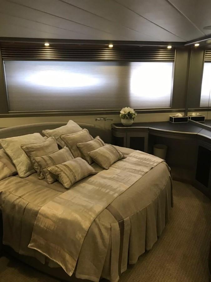 a bed with a large window aboard PERSHING 90/12 Yacht for Sale