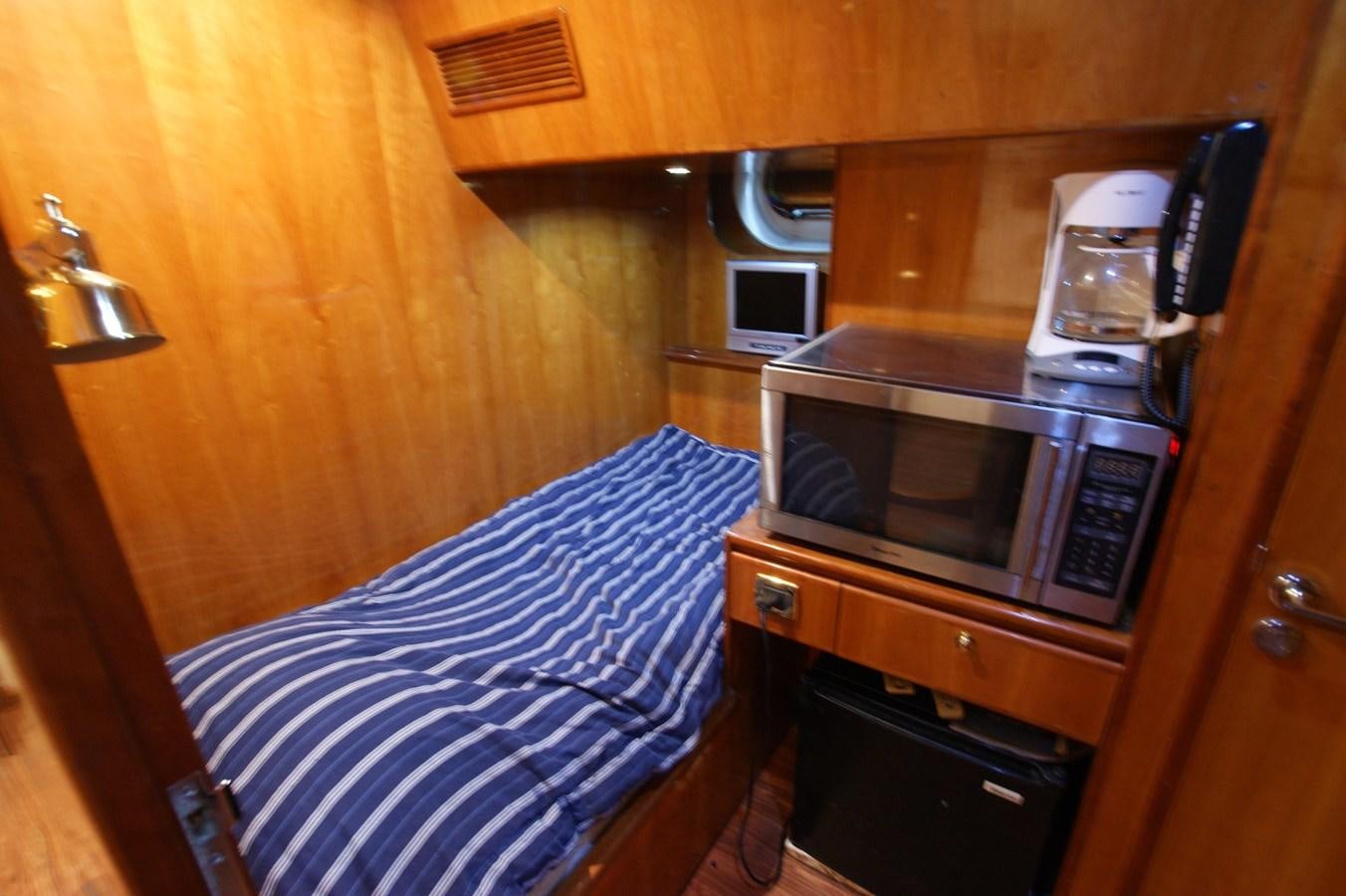a kitchen with a bed and microwave aboard LORI ANN Yacht for Sale