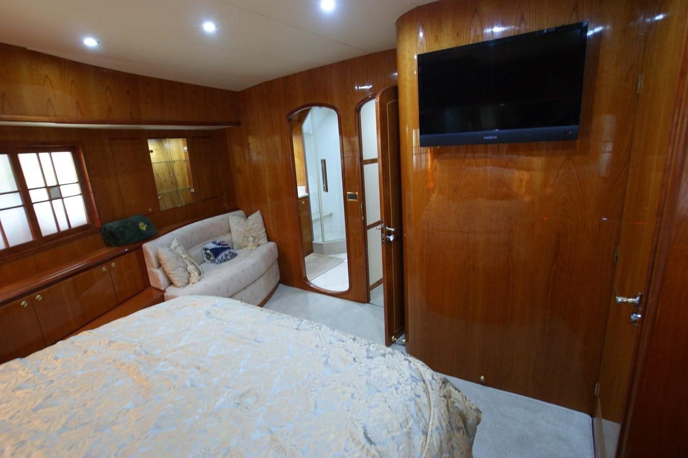 a bedroom with a bed and a television aboard LORI ANN Yacht for Sale