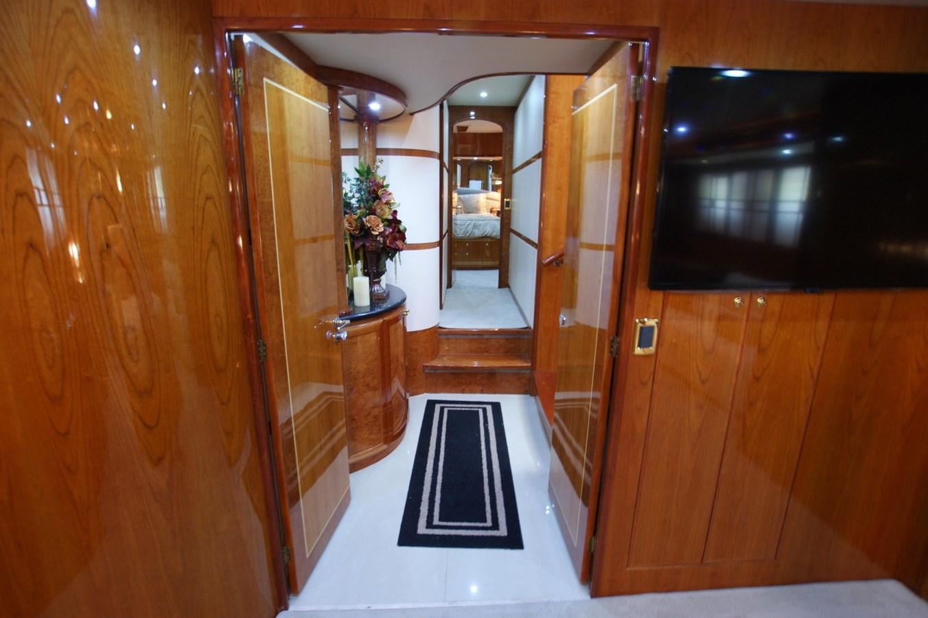 a room with a black and white rug and wood cabinets aboard LORI ANN Yacht for Sale