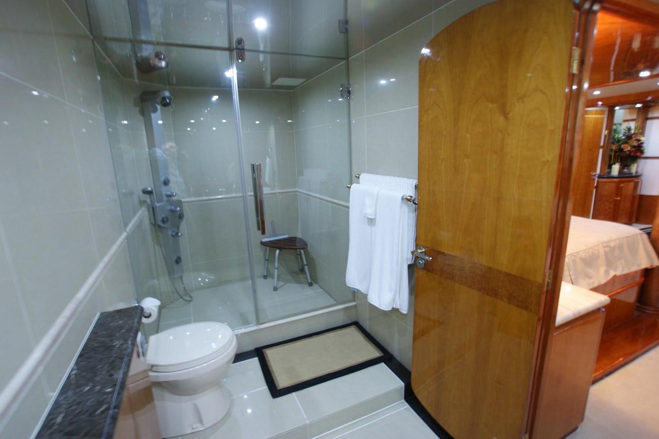 a bathroom with a glass shower aboard LORI ANN Yacht for Sale
