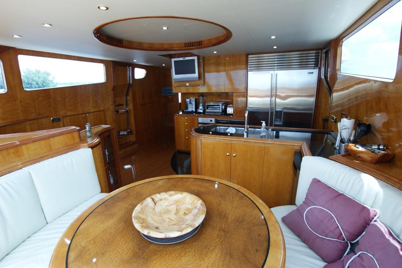 a room with a table and a couch aboard LORI ANN Yacht for Sale