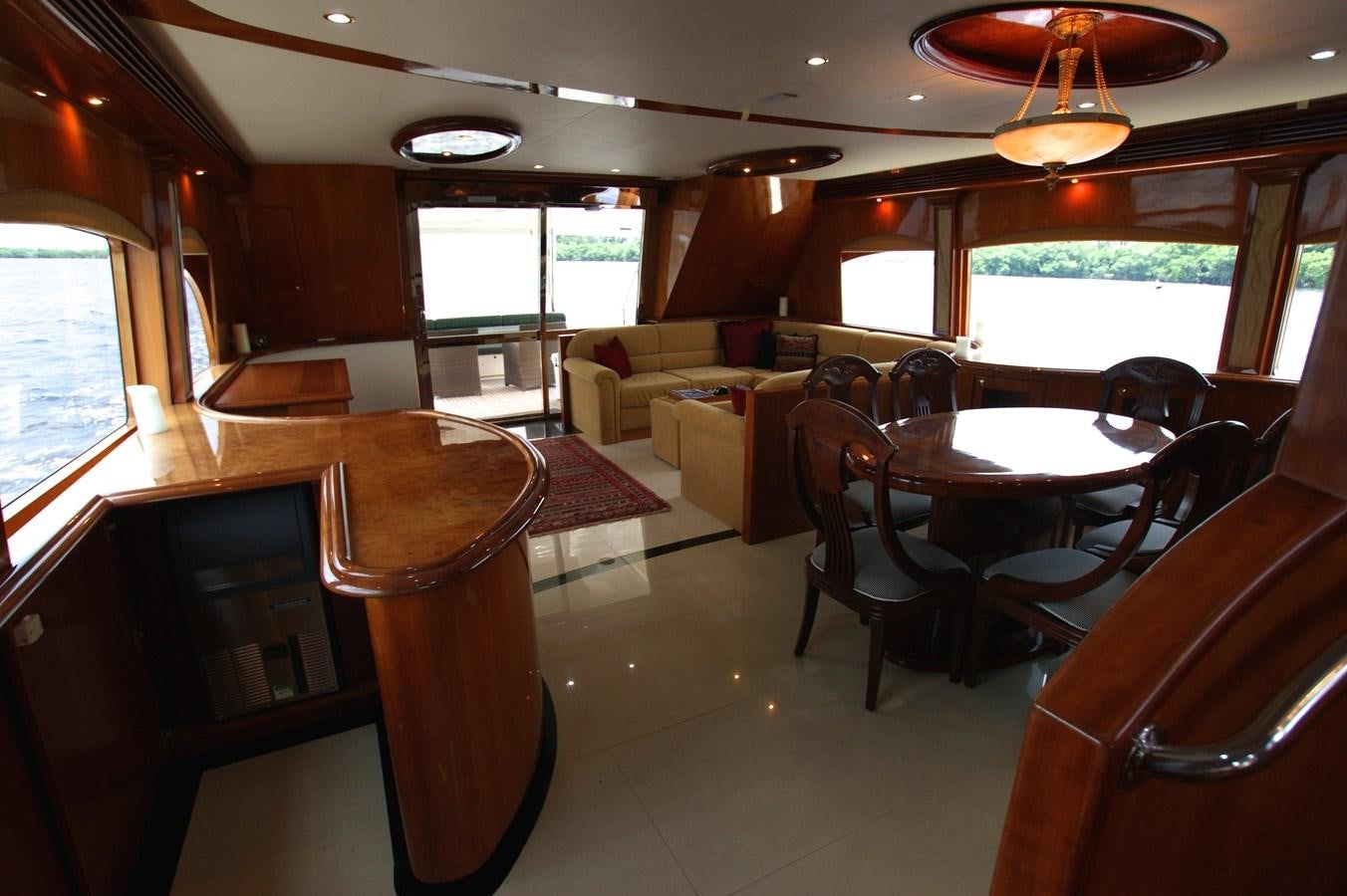 a large room with tables and chairs aboard LORI ANN Yacht for Sale