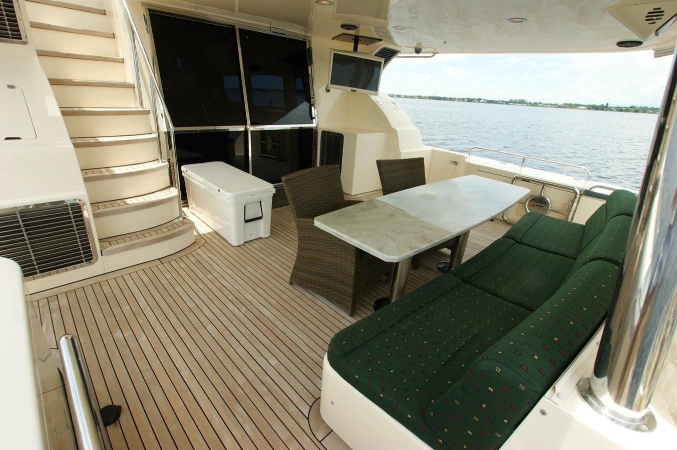a balcony with a table and chairs aboard LORI ANN Yacht for Sale