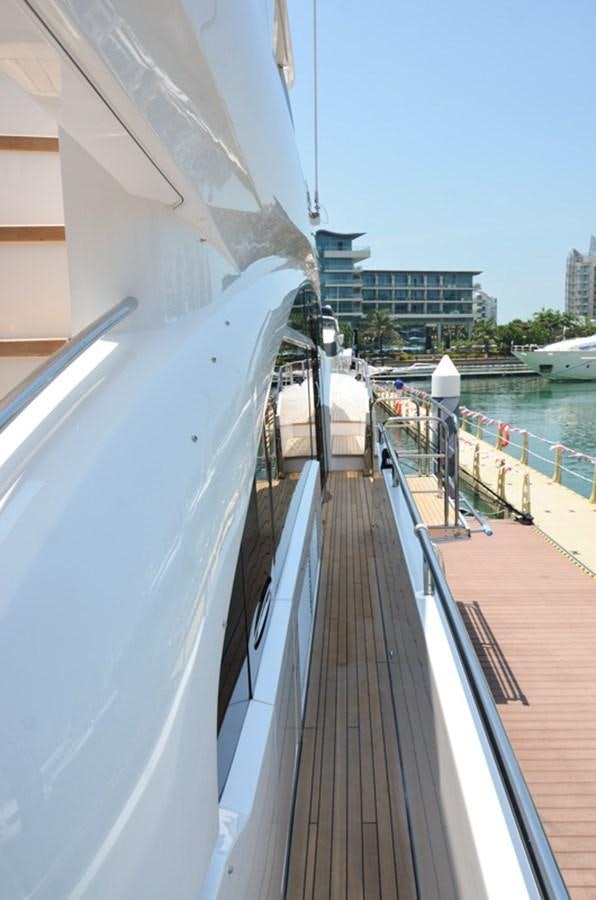 a deck with a railing and a body of water in the background aboard SEDNA Yacht for Sale