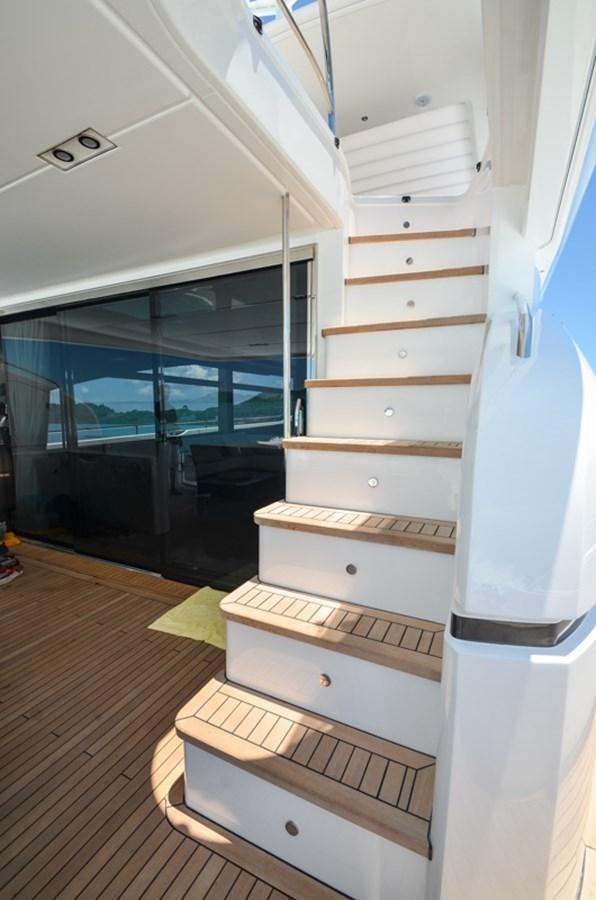 a white staircase with a wood railing aboard SEDNA Yacht for Sale