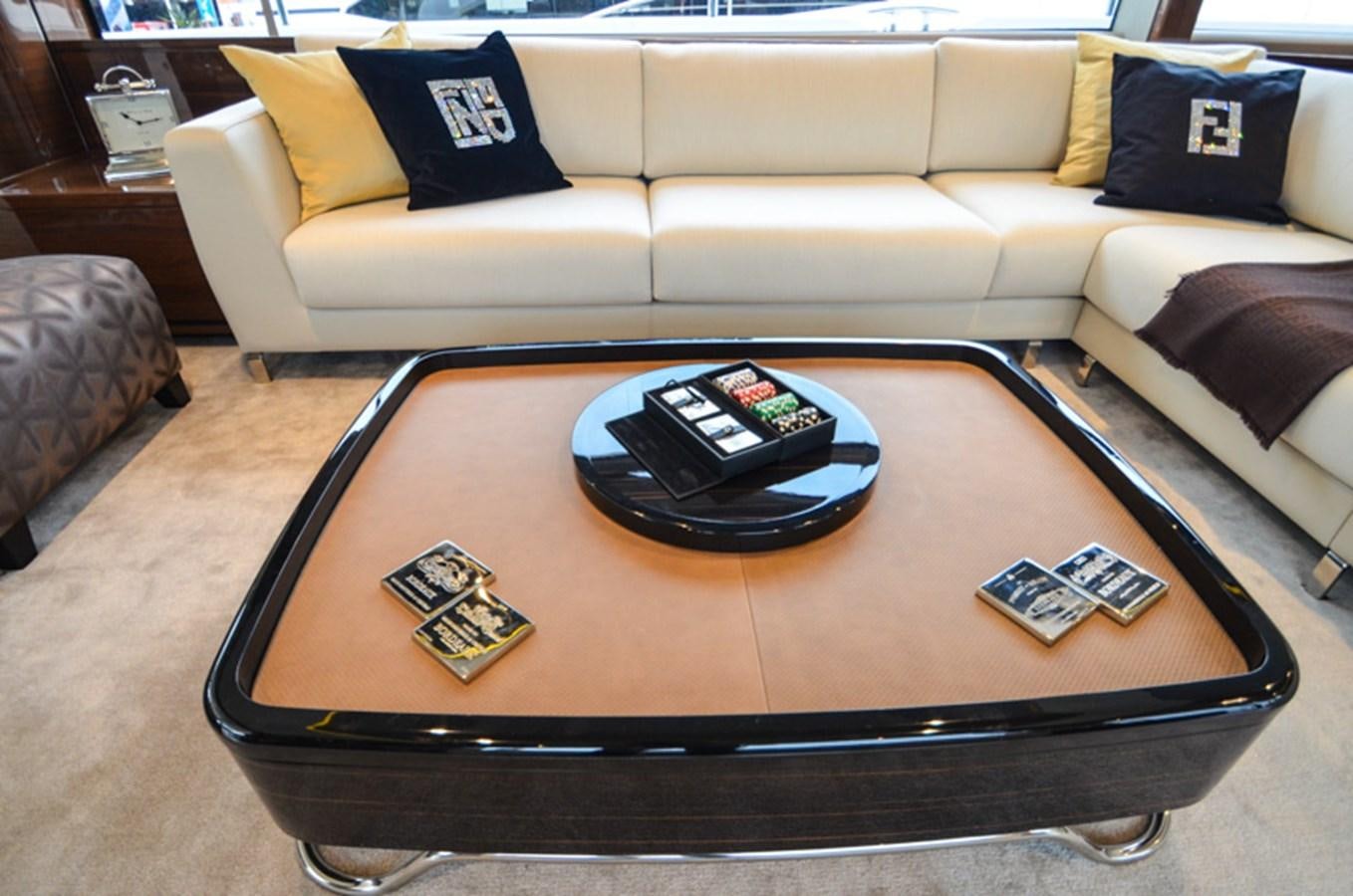 a coffee table with a laptop on it aboard SEDNA Yacht for Sale