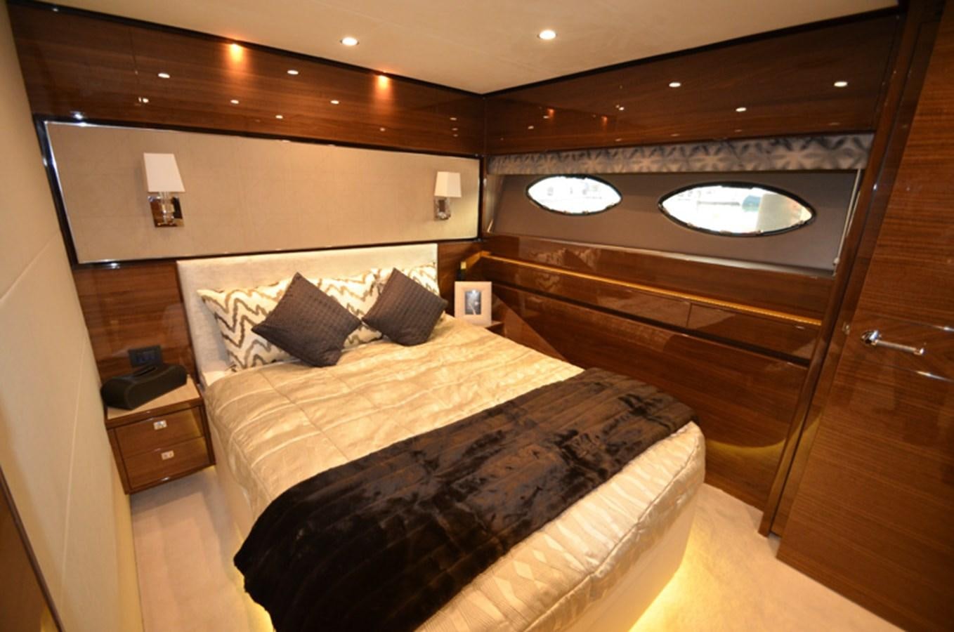 a room with a bed and a table aboard SEDNA Yacht for Sale