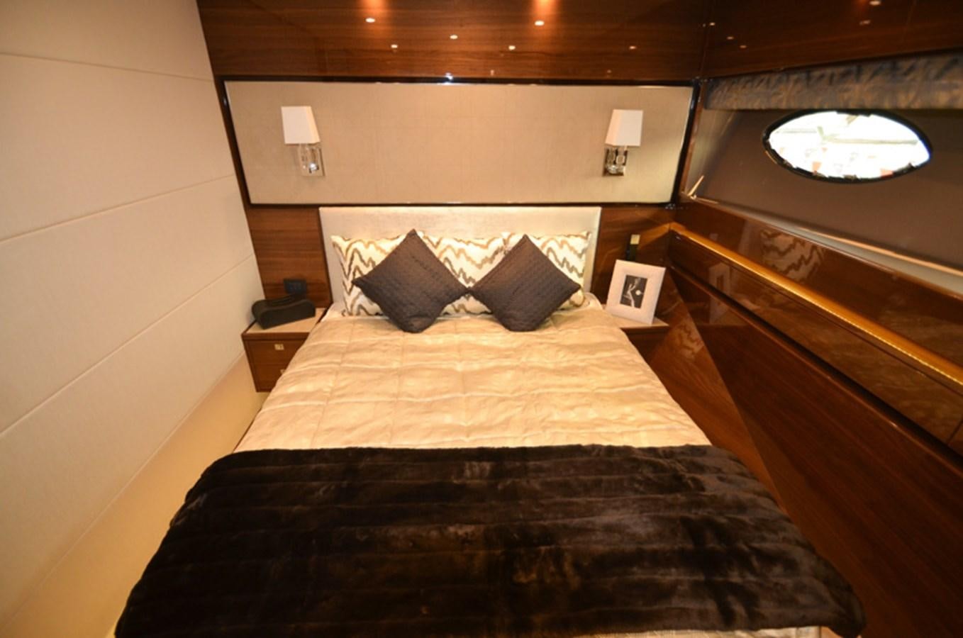 a bed with a black comforter aboard SEDNA Yacht for Sale