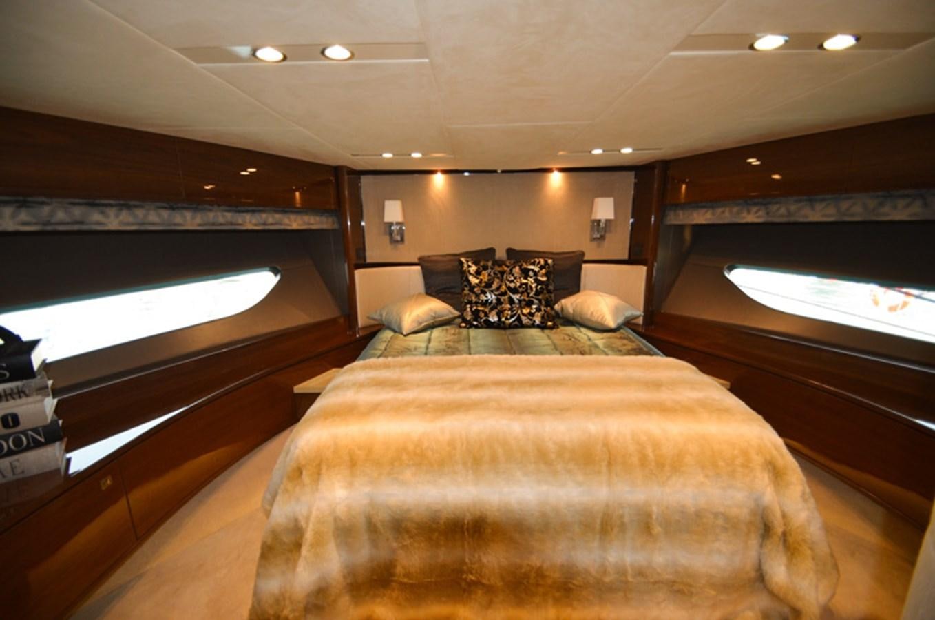 a bed with a brown bed spread aboard SEDNA Yacht for Sale