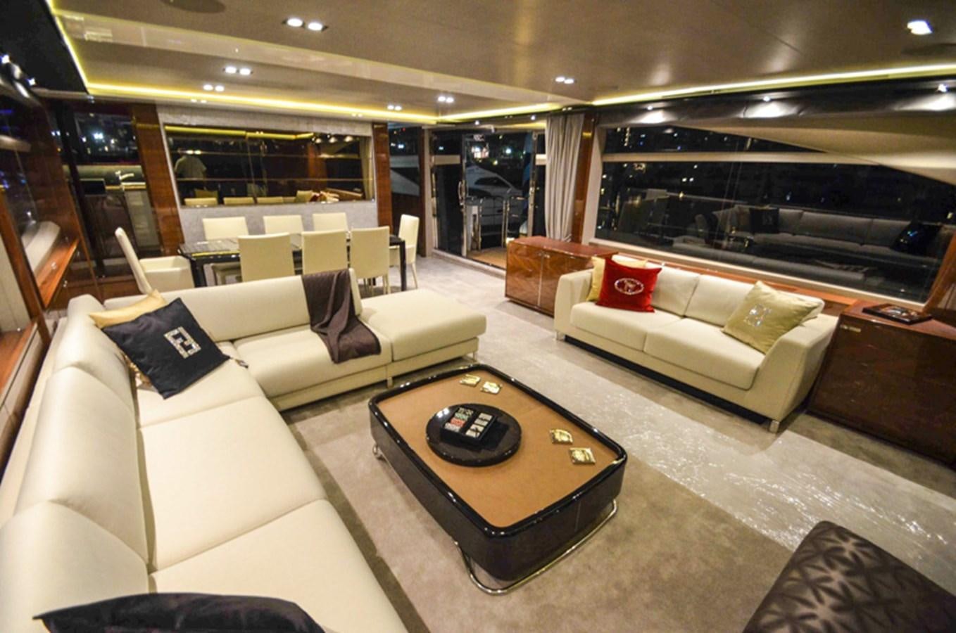 a large living room with white couches and a coffee table aboard SEDNA Yacht for Sale