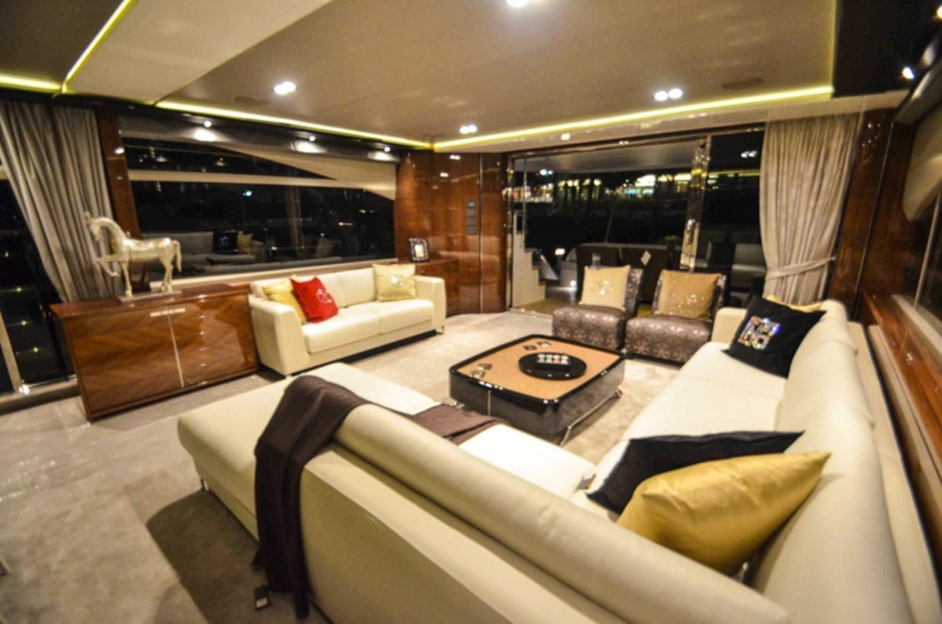 a large room with couches and a coffee table aboard SEDNA Yacht for Sale