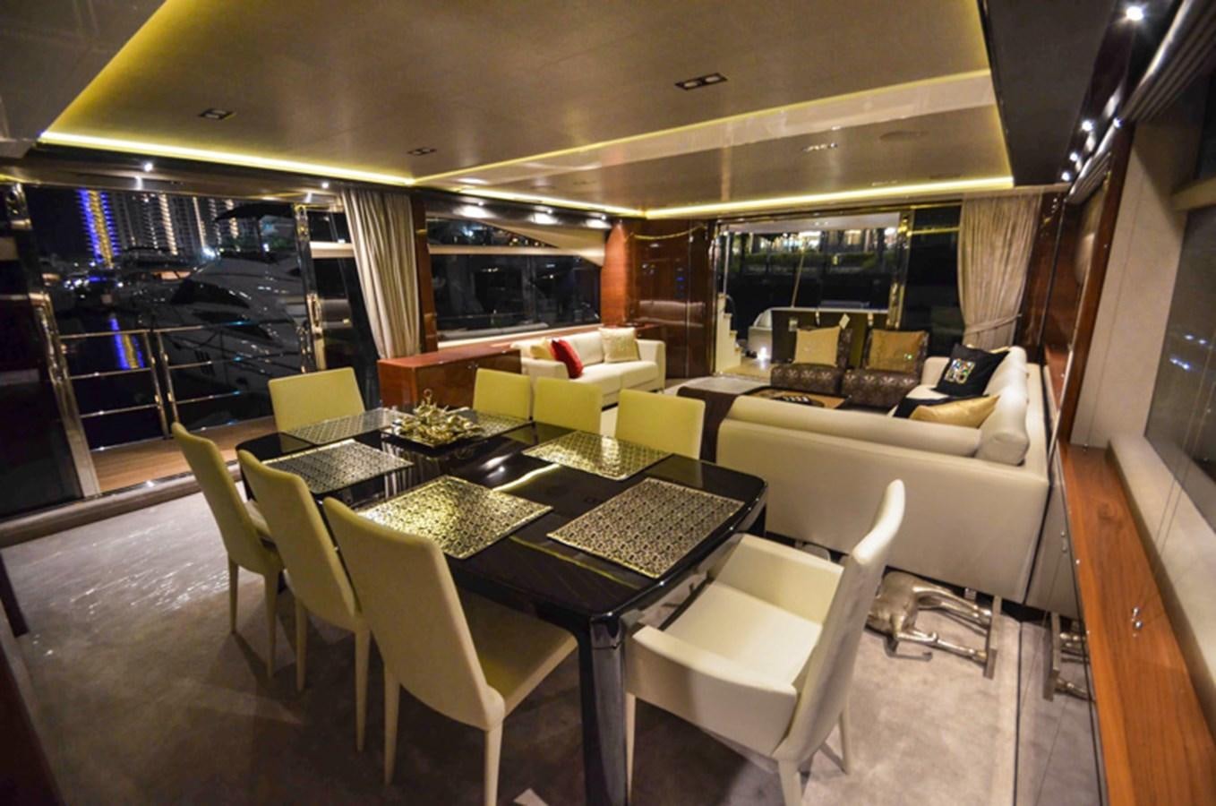 a room with a table chairs and a couch aboard SEDNA Yacht for Sale