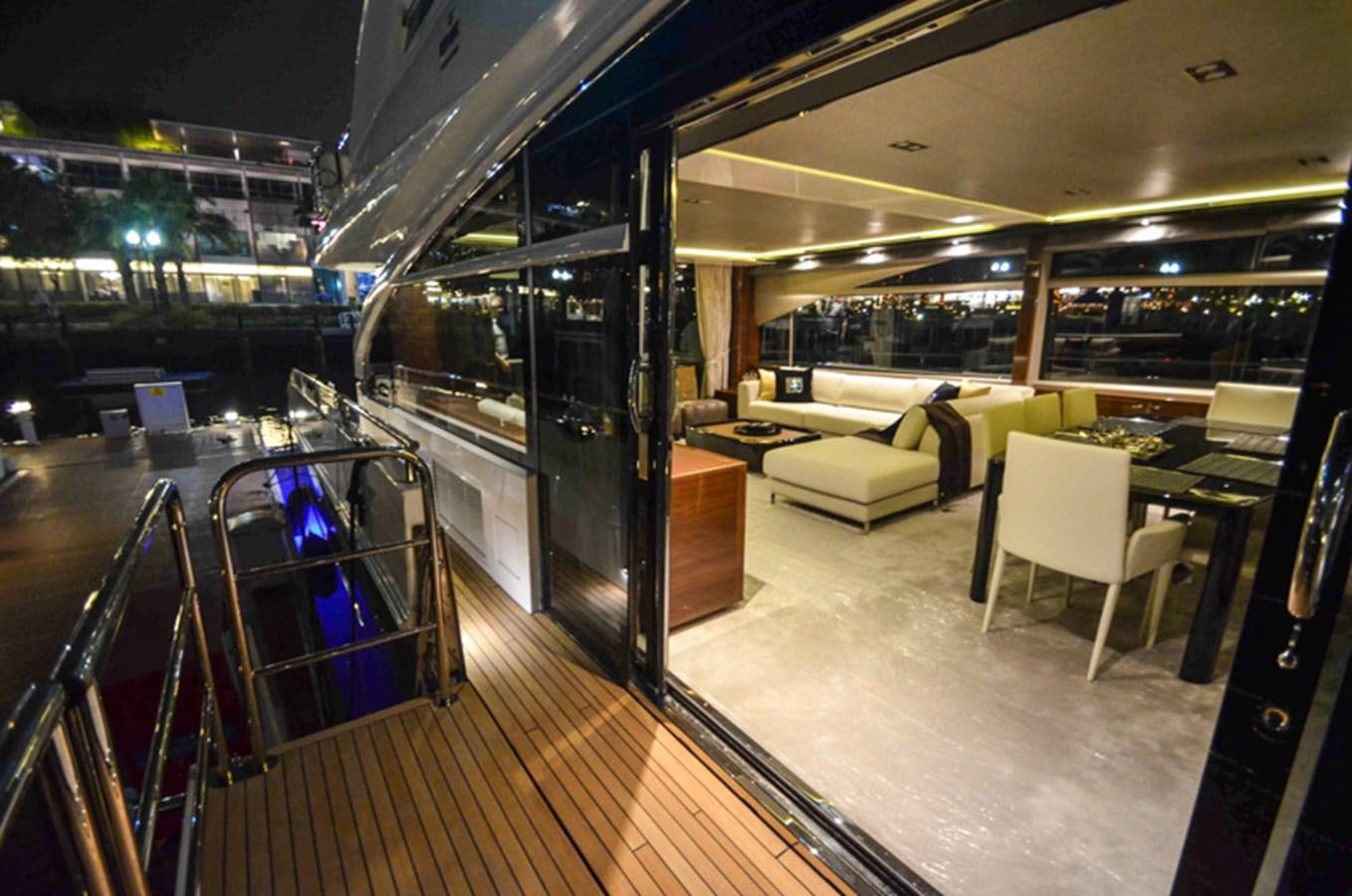 a room with a table chairs and a large glass door aboard SEDNA Yacht for Sale
