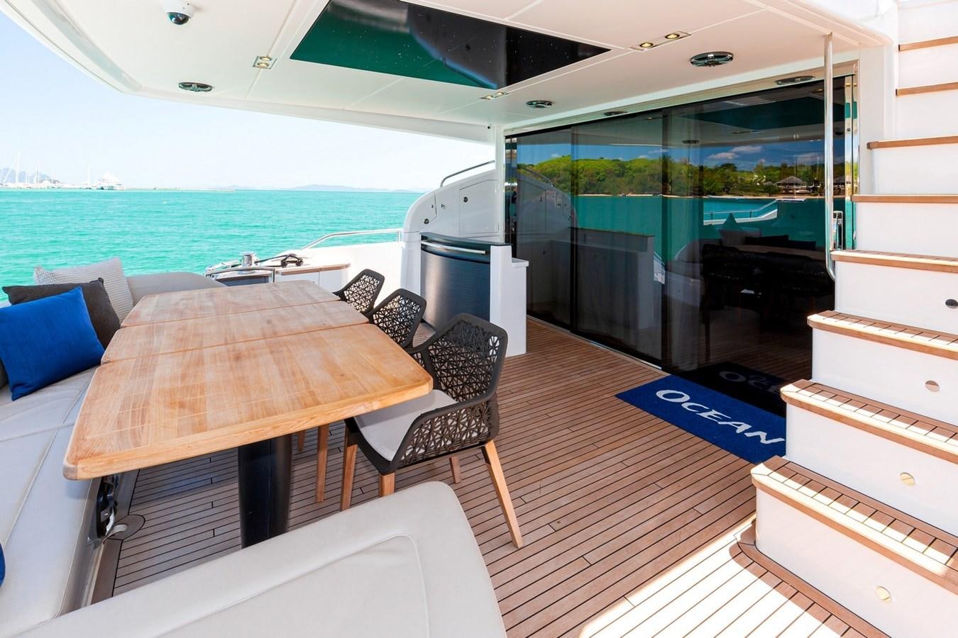 a table and chairs on a boat aboard OCEAN Yacht for Sale