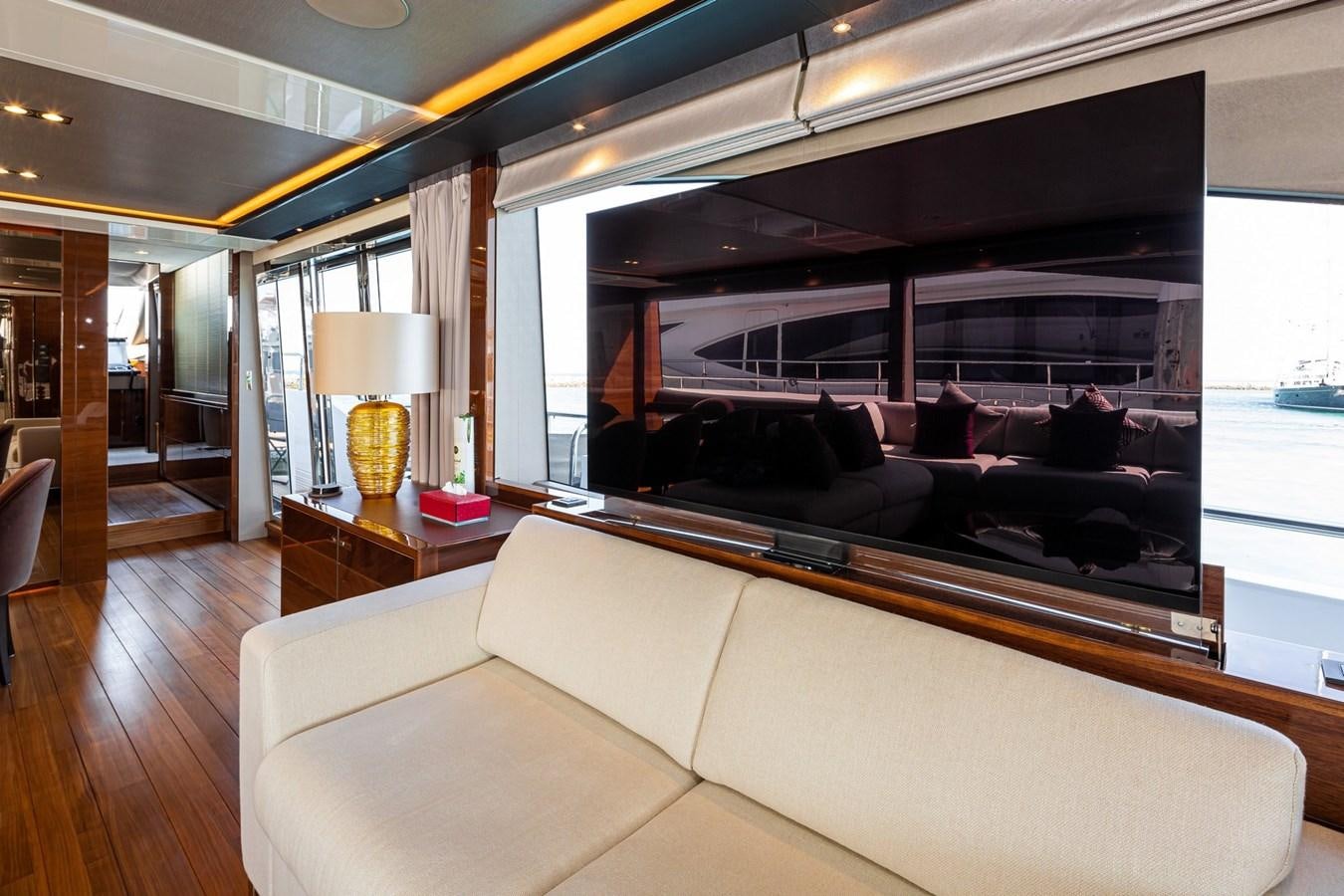 a living room with a large mirror aboard OCEAN Yacht for Sale