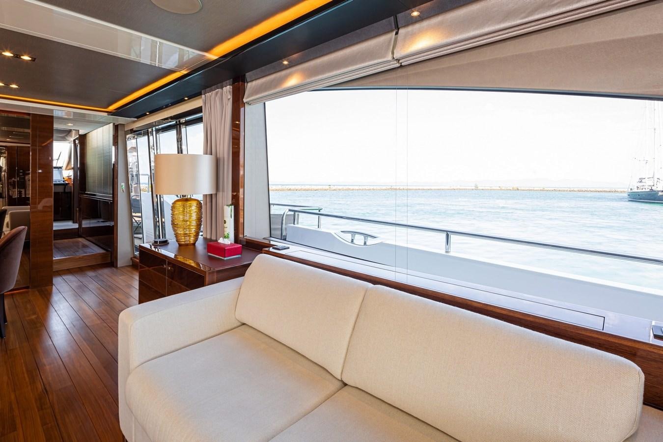 a living room with a large window aboard OCEAN Yacht for Sale