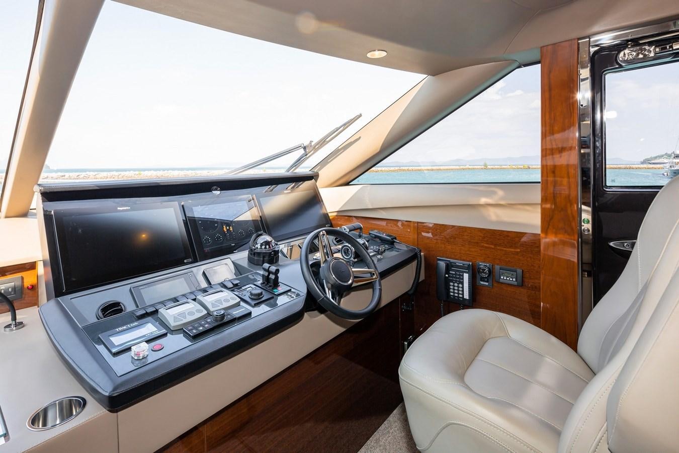 a room with a television and a couch aboard OCEAN Yacht for Sale